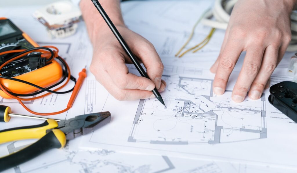 Someone working on electrical blueprint plans