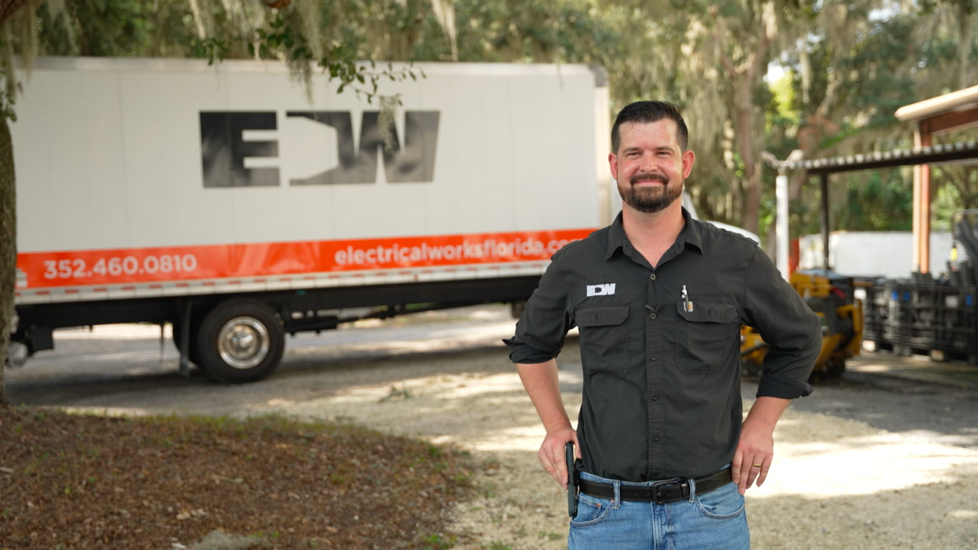 EW Employee standing next to truck