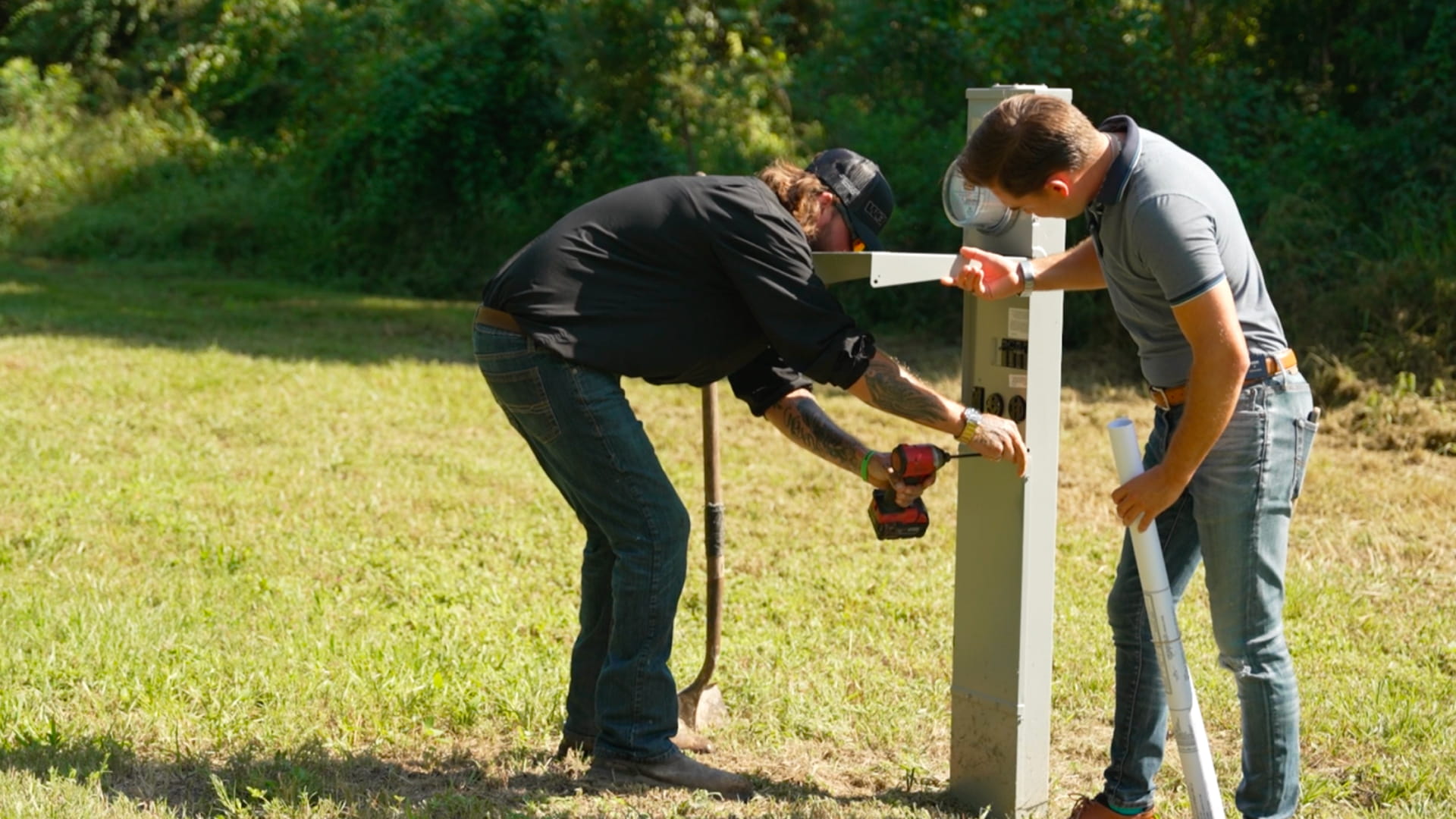 Two EW employees repairing a pedestal